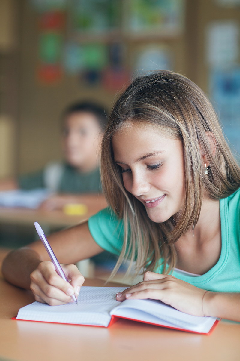 Student Writing in Book